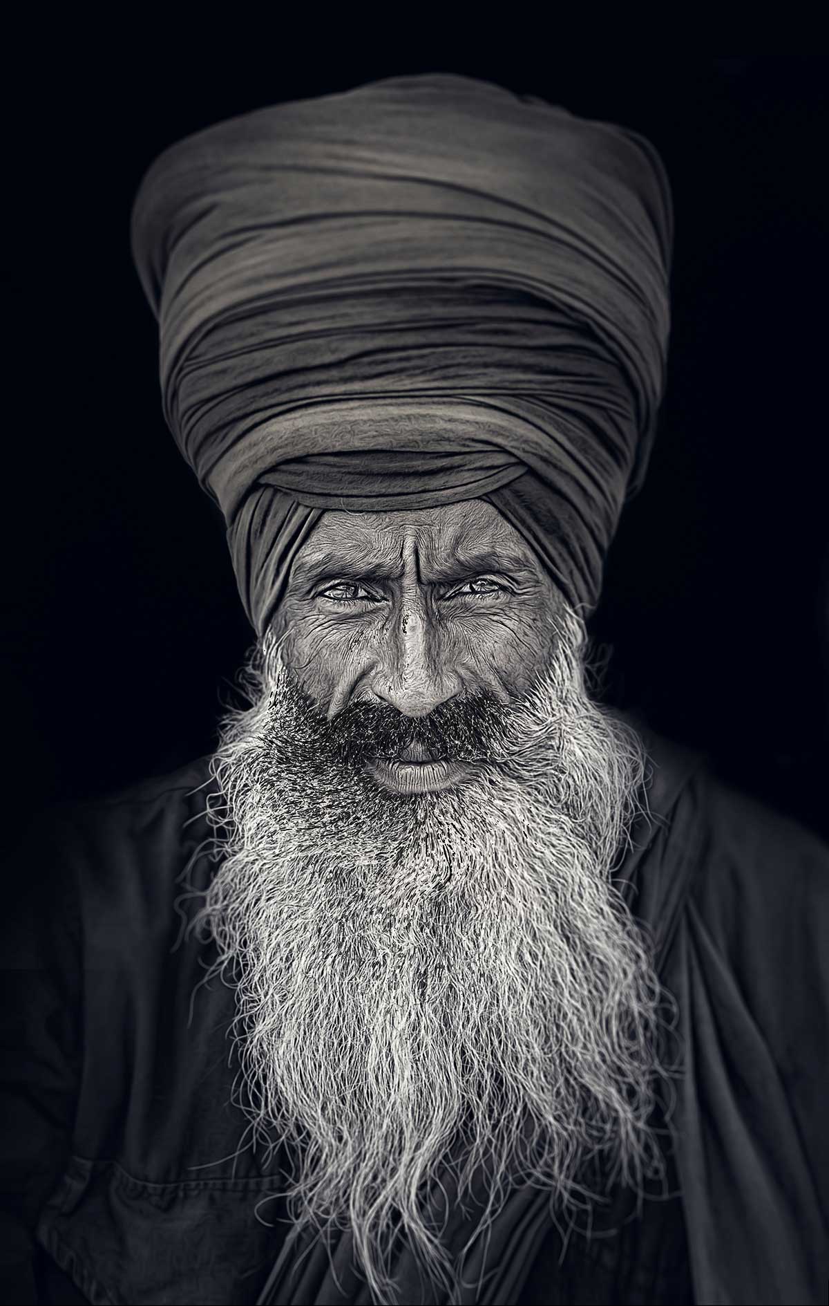 Portrait indian sikh man in turban with bushy beard. Amritsar, India. Close up